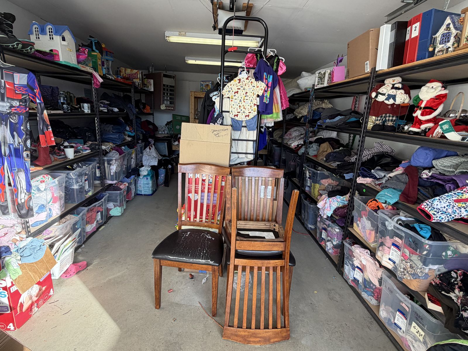 shelves of free clothing and household goods at a community free store, no people
